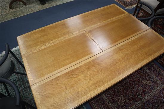 An Art Deco 1920s oak extending dining table L.137cm